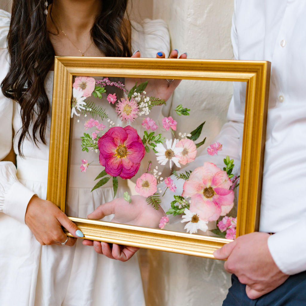 Preserved wedding bouquet in a frame with glass. Bride and groom flowers 