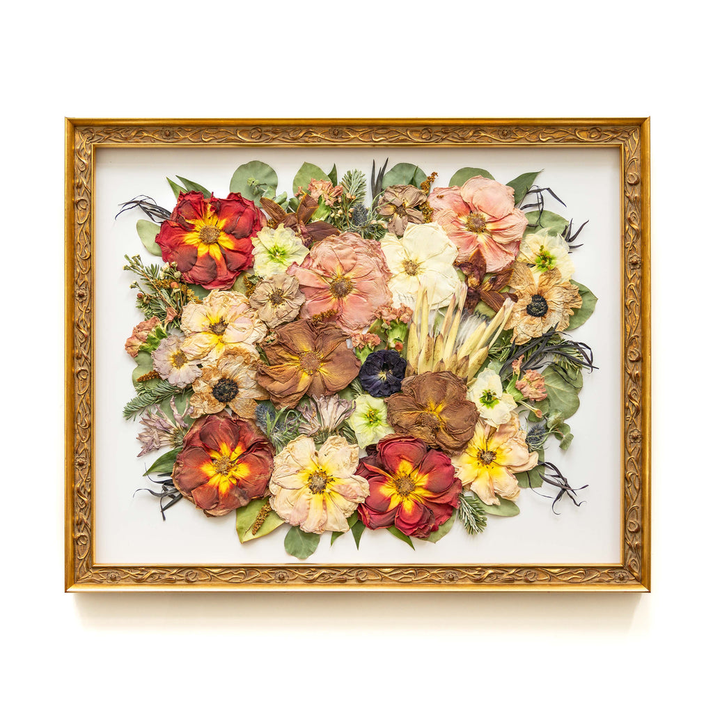 A stunning 16x20 antique gold floral frame adorned with a breathtaking display of pressed flowers. The arrangement boasts vibrant red roses, striking proteas, and elegant pink roses, meticulously preserved to showcase their exquisite colors and textures.